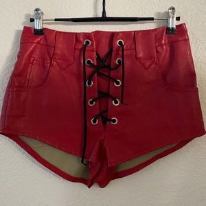 Red faux leather lace up shorts